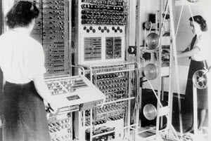  Colossus Mark 2 computer being operated by Wrens (female navy personnel). On the left is a slanted control panel which was used to set the 